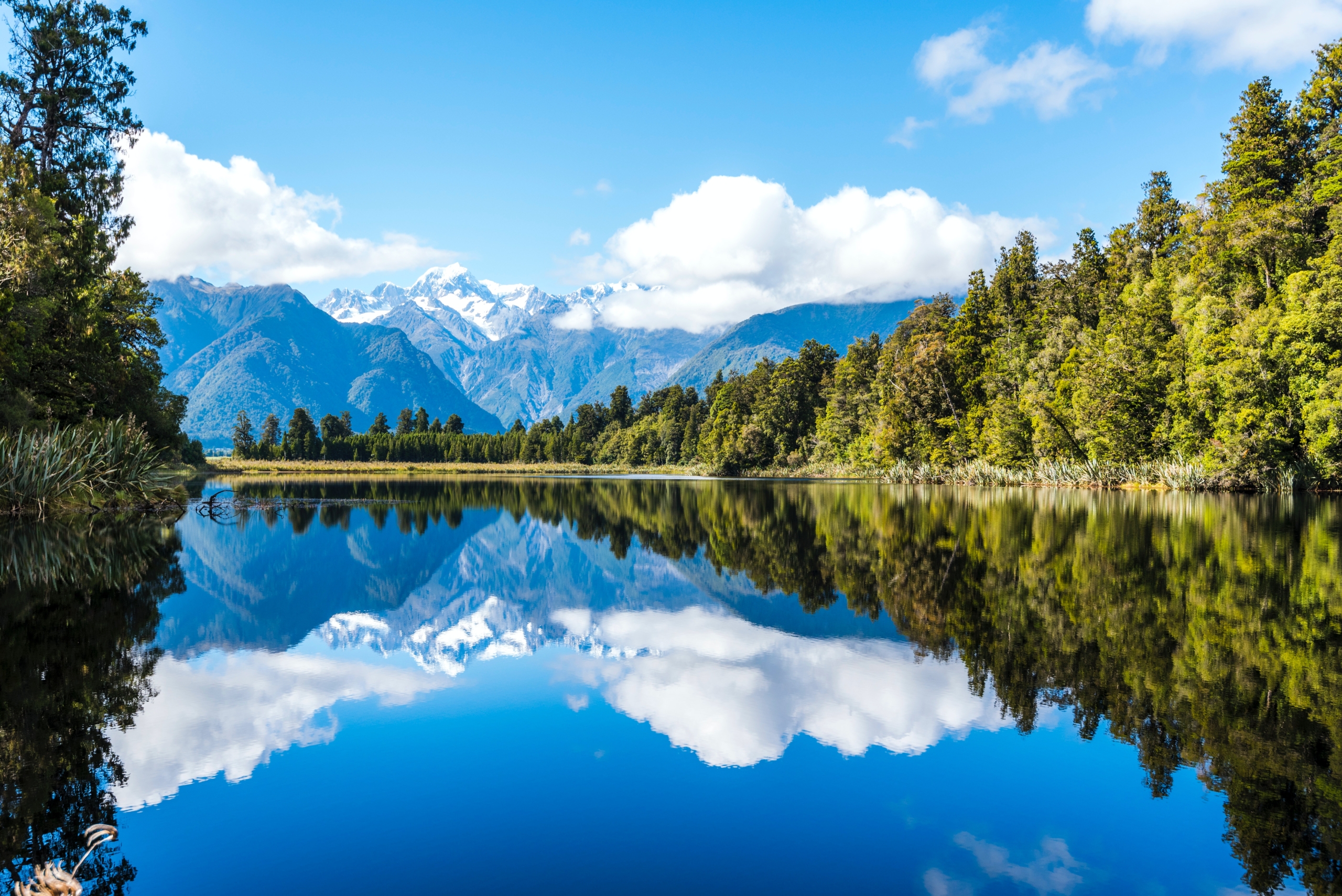 Picture of a lake with trees and mountains in the background