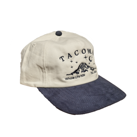 Tacoma Baseball Cap. Cream top with navy embroidery and a navy corduroy bill